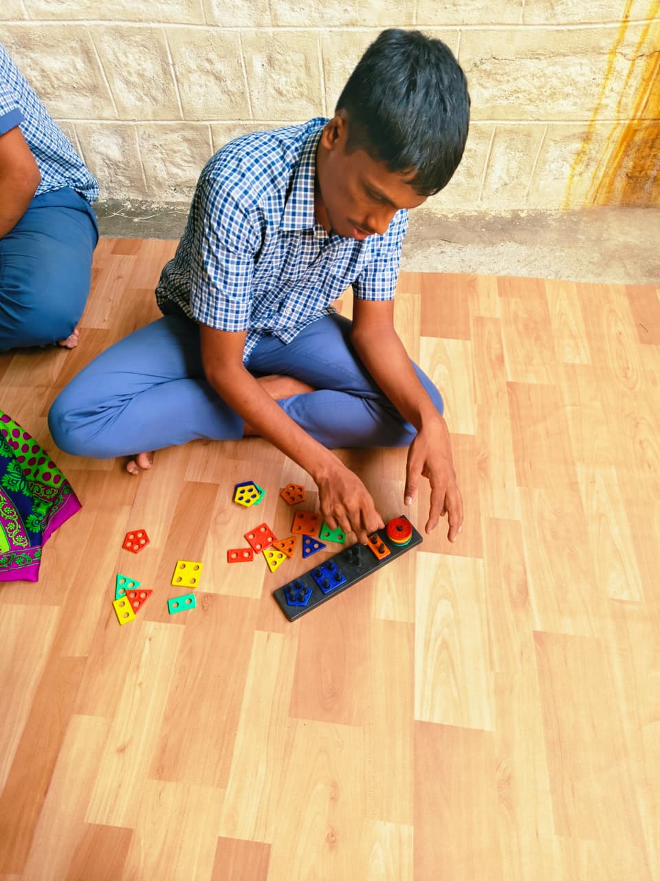 Student matching colourful shapes on a classroom activity board